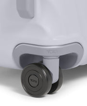 Load image into Gallery viewer, Close up to the wheel of the suitcase. The TUMI logo is featured on the center.
