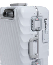 Load image into Gallery viewer, Close up to the side panel of the suitcase. Featuring a grab handle, a tag, and a set of TSA approved three-digit combination locks. 
