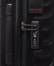 Load image into Gallery viewer, Close up to the side panel showing a grab handle, a tag, and a TSA approved three-digit combo lock. 
