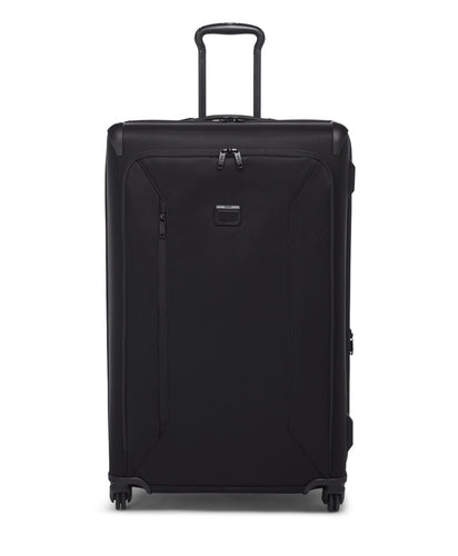 Front panel view of the black suitcase. The telescopic handle is partly extended. 