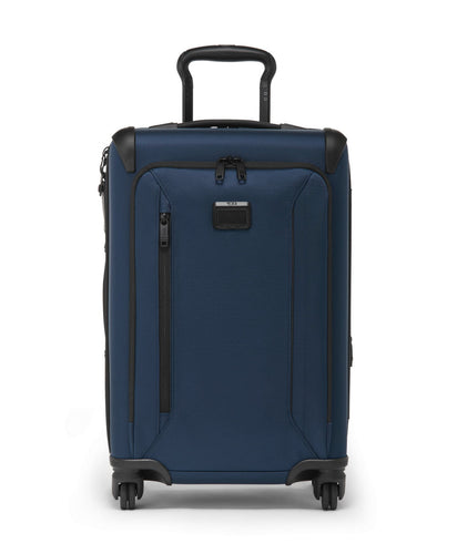 Front panel view of the blue suitcase with black accents. The telescopic handle is partly extended. 