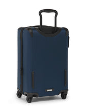 Load image into Gallery viewer, Angled back panel view of the blue suitcase. 
