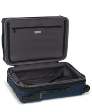 Load image into Gallery viewer, Interior view of the suitcase showing a dark gray lining with a zipper-closing panel divider on the front, and a set of adjustable straps to hold your contents on the back panel. 
