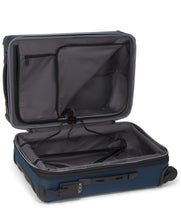 Load image into Gallery viewer, Interior view of the blue suitcase with the panel divider opened and showing a garment hanger. 
