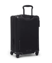 Load image into Gallery viewer, Angled back panel view of the black suitcase. The telescopic handle is partly extended.
