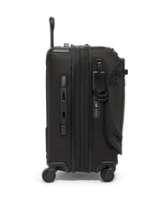 Load image into Gallery viewer, Side panel view of the suitcase. It features a tag, a grab handle, and a TSA approved three-digit combination lock. 
