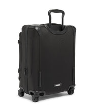 Load image into Gallery viewer, Angled back panel view of the black suitcase. The telescopic handle is partly extended. 
