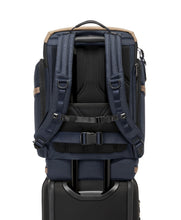Load image into Gallery viewer, Back panel view with the attachment strap holding the backpack to the telescopic handle of a suitcase.
