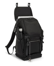 Load image into Gallery viewer, Angled front view of the backpack with the front flap lifted, showing a laptop peaking from the compartment. 
