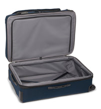 Load image into Gallery viewer, Interior view of the suitcase showing the zipper-closing panel divider on the front panel, and a set of straps on the back panel to hold your contents in place. 
