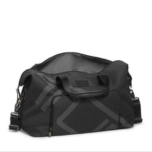 Load image into Gallery viewer, Angled front panel view of the satchel featuring two grab handles at the top and an removable shoulder strap. The main compartment is unzipped. 
