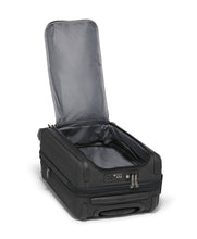 Load image into Gallery viewer, Angled view of the suitcase laid on the front panel with the back panel unzipped and lifted. 
