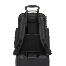 Load image into Gallery viewer, Back panel view of the backpack showing the attachment feature. This allows for the telescopic handle of a suitcase to slide through and keep the backpack in place. 
