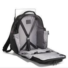 Load image into Gallery viewer, Interior view of the backpack showing the front panel completely unzipped. A set of adjustable straps are available to hold your contents in place. 
