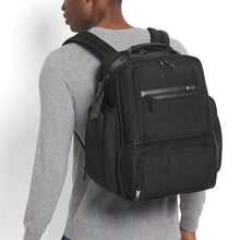Load image into Gallery viewer, A young man carrying the backpack on his shoulders. Set on a white background. 
