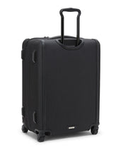 Load image into Gallery viewer, Angled back panel view of the suitcase with the telescopic handle extended. 
