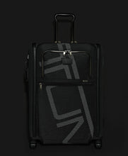 Load image into Gallery viewer, Front panel view of the suitcase on a black background. 
