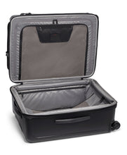 Load image into Gallery viewer, The suitcase laid on its back with the front panel lifted. It shows a zipper-closing panel divider and organizational pockets. 
