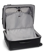 Load image into Gallery viewer, Interior view of the suitcase showing the front panel&#39;s foldable garment bag. 
