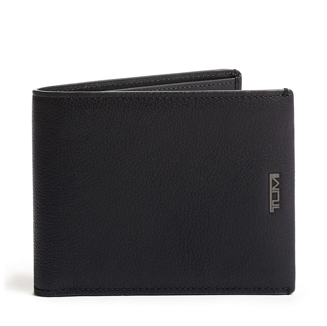 A black textured leather wallet with a flip design, featuring the Tumi logo on the bottom right corner.