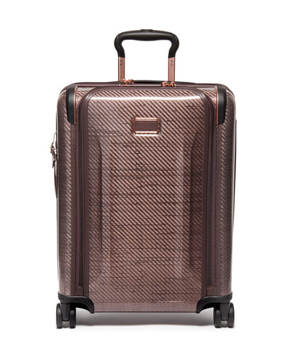 Front panel view of the blush suitcase with black accents. 