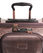 Load image into Gallery viewer, Close up to the top panel of the suitcase. It features a grab handle, and a TSA approved three-digit combination lock. 

