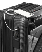 Load image into Gallery viewer, Angled close up to the top of the suitcase. There is a three-digit combination lock, and a USB plug on the side panel above the tag. You can charge your mobile devices with it. A battery bank is required, and not included. 
