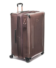 Load image into Gallery viewer, Angled front panel view of the suitcase with the telescopic handle partly extended. 
