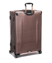 Load image into Gallery viewer, Angled back panel view of the bush colored suitcase with black accents. 
