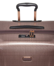 Load image into Gallery viewer, Close up to the top panel of the suitcase. It features a grab handle and a TSA approved three-digit combination lock. 
