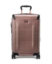 Load image into Gallery viewer, Front panel view of the blush colored suitcase with black accents. 
