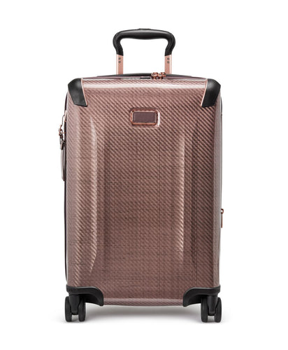 Front panel view of the blush colored suitcase with black accents. 