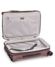 Load image into Gallery viewer, Interior view of the suitcase. The front side has a zipper-closing panel divider with a pocket. The back side has a set of adjustable straps to hold your contents in place. 
