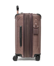 Load image into Gallery viewer, Side panel view of the blush suitcase with the expandable feature unzipped. It  has a grab handle, and a tag. 
