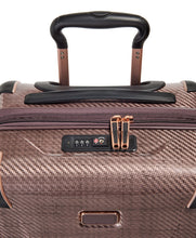 Load image into Gallery viewer, Close up to the top panel of the suitcase. it features a black grab handle and a TSA approved three-digit combination lock.
