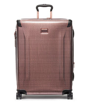 Load image into Gallery viewer, Front panel view of the blush colored suitcase with black accents. The telescopic handle is partly extended. 
