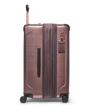 Load image into Gallery viewer, Side panel view of the suitcase with the expandable feature unzipped. It features a grab handle, and a luggage tag.
