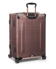 Load image into Gallery viewer, Angled back panel view of the suitcase with the telescopic handle extended. 

