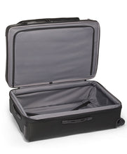 Load image into Gallery viewer, Interior view of the suitcase showing a zipper-closing divider on the front panel, and a set of straps on the back panel to hold your contents. 
