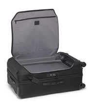 Load image into Gallery viewer, The suitcase laid on its back with the front panel&#39;s pocket unzipped and lifted. 
