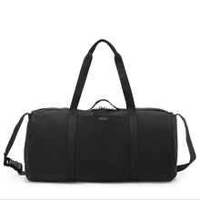 Load image into Gallery viewer, Front panel view of the duffle bag featuring an adjustable shoulder strap and grab handles. 
