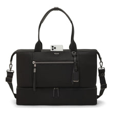 Load image into Gallery viewer, Front panel view o the bag showing a cellphone peeking form the pocket under the grab handles. 
