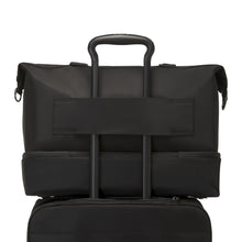 Load image into Gallery viewer, Back panel view showing the attachment strap feature. This allows the telescopic handle of a suitcase or trolley to slide through, and keep the bag in place. 
