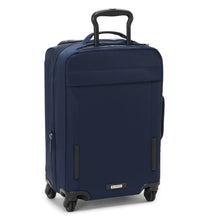 Load image into Gallery viewer, Angled back panel view of the indigo blue suitcase with the telescopic handle partly extended. 
