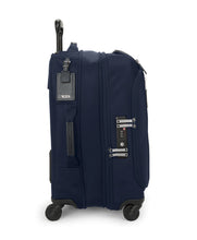 Load image into Gallery viewer, Side panel view of the suitcase with the expandable feature shown. There is a tag, a grab handle, and a TSA approved three-digit combination lock
