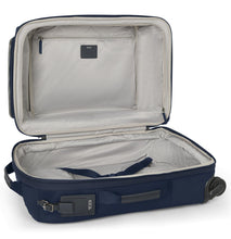 Load image into Gallery viewer, Interior view of the suitcase showing a light gray lining, a zipper compartment, and a set of adjustable straps to hold contents in place. 
