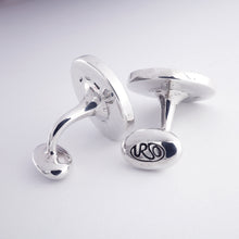Load image into Gallery viewer, Silver cufflinks showing the engraved URSO logo on a light gray background
