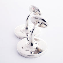 Load image into Gallery viewer, The silver cufflinks arranged on a white background.
