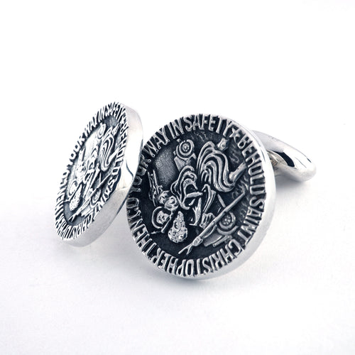 Two circular cufflinks with engraved design on a white background. The engraved text around the design reads: 