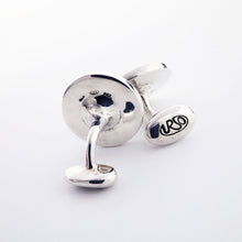 Load image into Gallery viewer, The two silver cufflinks arranged on a light gray background. 
